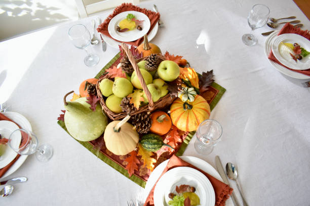 istock Fall harvest dinner table decorative centrepiece with autumn squash, pumpkins and apples 1350701808