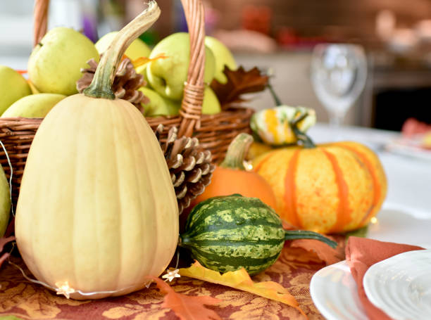 istock Fall harvest dinner table decorative centrepiece with autumn squash, pumpkins and apples 1350701842