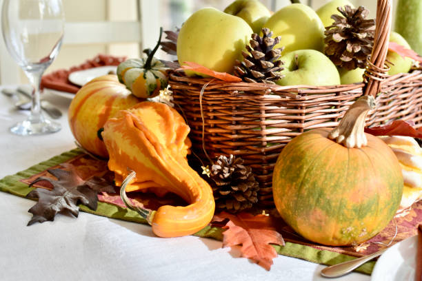 istock Fall harvest dinner table decorative centrepiece with autumn squash, pumpkins and apples 1350701845