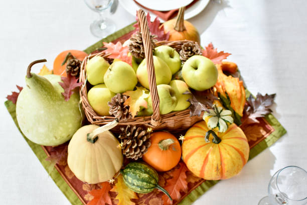 istock Fall harvest dinner table decorative centrepiece with autumn squash, pumpkins and apples 1350701875