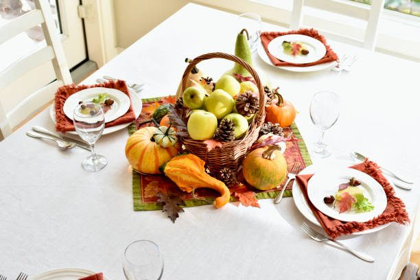 istock Fall harvest dinner table decorative centrepiece with autumn squash, pumpkins and apples 1350701923