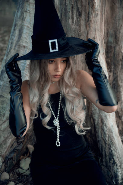 istock Blonde woman dress as witch 1350701931