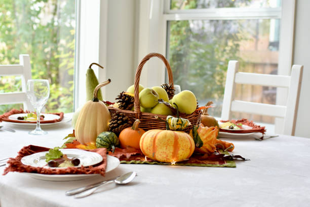 istock Fall harvest dinner table decorative centrepiece with autumn squash, pumpkins and apples 1350701952
