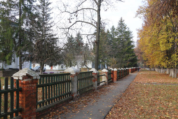 istock Autumn landscape. Walking path along the stone fence. 1350702274