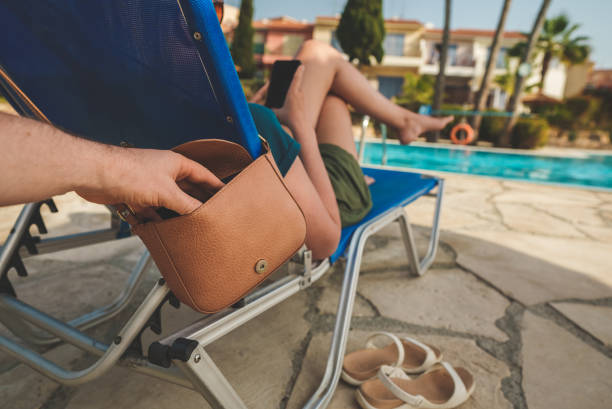 Thief stealing a bag from a woman on vacation. Thief stealing a bag from a woman on vacation. pickpocketing stock pictures, royalty-free photos & images