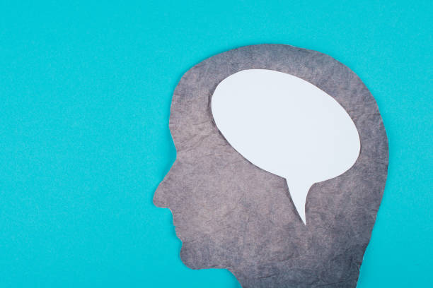 istock Silhouette of a face made with scrambled paper, speech bubble in white color, copy space for text, communication, symbolic 1350711516