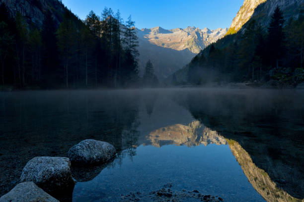 istock Fog from the lake discover mountain reflection 1350711727