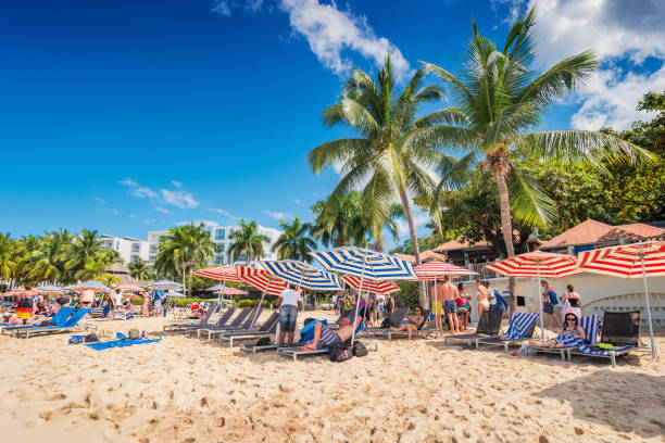 People enjoy Doctor's Cave Beach in Montego Bay Jamaica on a sunny day.
