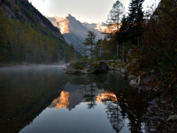 istock Fog from the lake discover mountain reflection 1350711782
