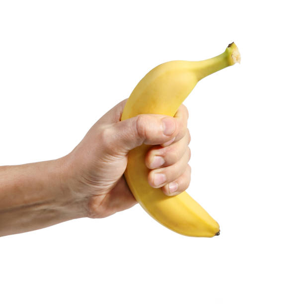 istock Banana in hand isolated on white close-up 1350712588