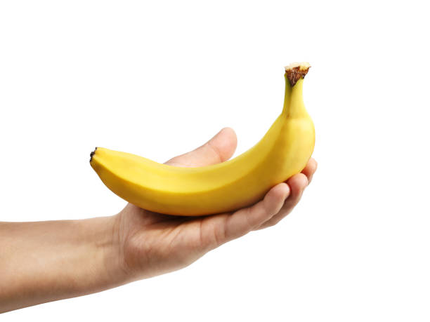 istock Banana in hand isolated on white close-up 1350713157