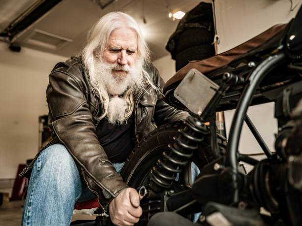 istock Senior man working on his motorcycle 1350713454