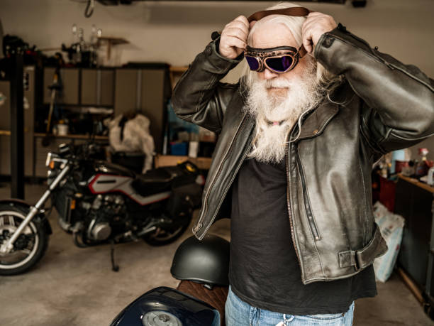 istock Senior man getting ready to ride his motorcycle 1350713473