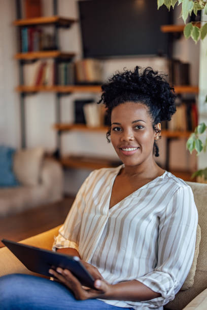 istock African-american woman, checking her new tablet 1350713532