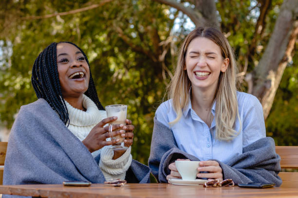 istock Two young girlfriends enjoying coffee together in a coffee shop. 1350716445