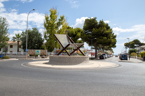 The main roundabout taken on the beautiful island of Majorca in Spain showing a giant deck chair in the middle