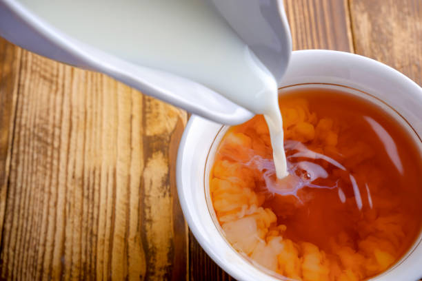 istock cup of tea with milk on a wooden table 1350721242