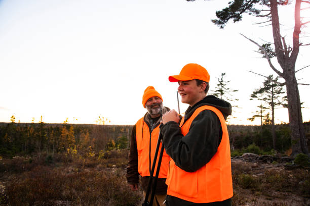 A teen deer hunter with his father