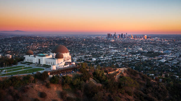 Aerial view of Griffith Observatory and Los Angeles city skyline at sunset Aerial view of Griffith Observatory and Los Angeles city skyline at sunset, California griffith park photos stock pictures, royalty-free photos & images
