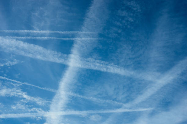 istock jet airplane  contrails crossings in blue sky 1350727845