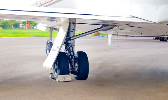 Airplane landing gear detail on runway airport