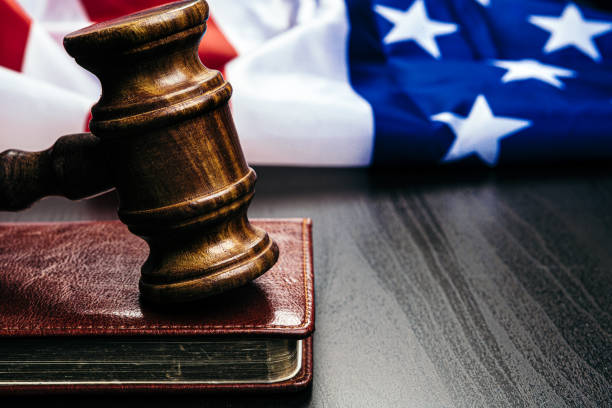 istock Gavel on wooden table with USA flag 1350728932