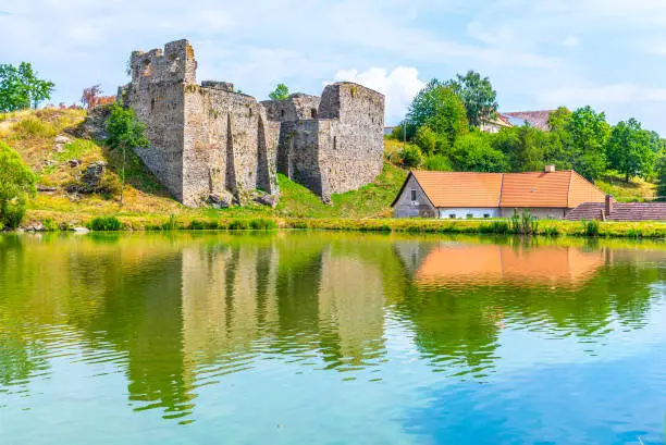 Borotin Castle ruins with romantic pond in the foreground, Borotin, South Bohemia, Czech Republic.
