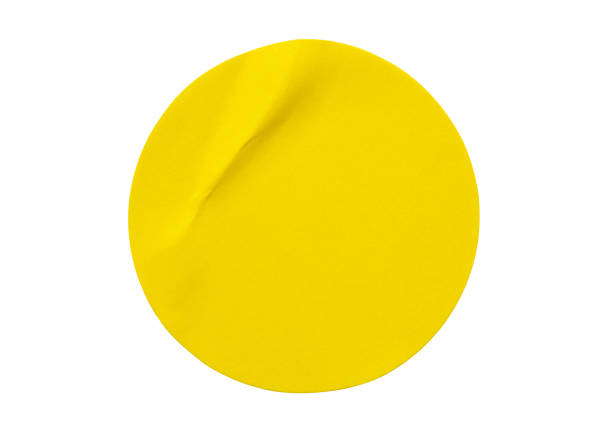 istock Yellow round paper sticker label isolated on white background 1350730475