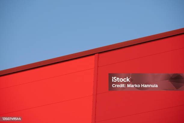 Closeup Of Red Metallic Building Wall Against Bright Blue Sky During The Sunset Stock Photo - Download Image Now