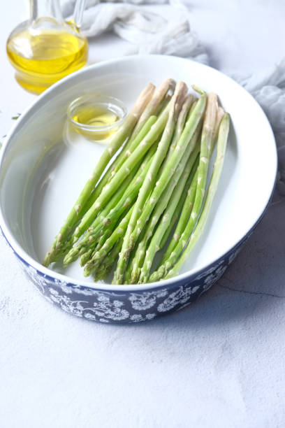 istock Asparagus green in a bowl with oil on table 1350750450