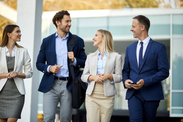 istock Four young executives talking on the street 1350751079