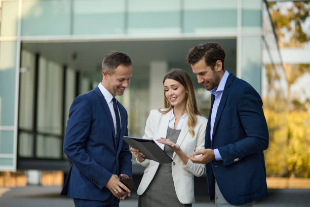 istock Business team working online on digital tablet outdoors 1350751140
