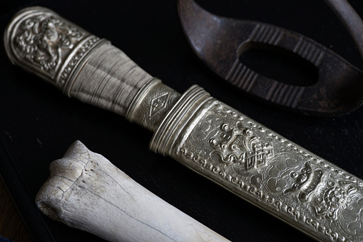 Tibetan broadsword is typical manner of wearing for tibetan adults. Usually budista symbols carved on scabbard.