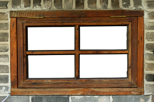 Wooden window on grey brick wall