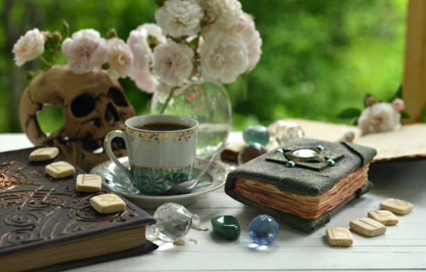 istock Vintage summer still life with old book, crystals and runes on witch ritual table. 1350758901