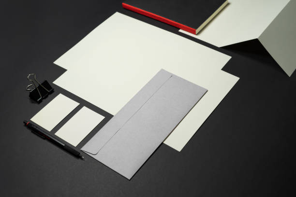 istock Stationery branding mockup template with red A4 Letterhead, business card, envelope, note bookpencil.  Dark background real photography