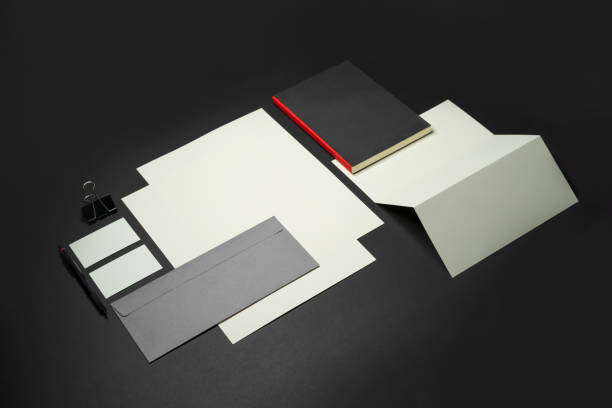 istock Stationery branding mockup template with red A4 Letterhead, business card, envelope, note bookpencil.  Dark background real photography