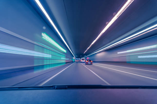 istock Driving fast through a city underground with blurry lights effect as a concept for high speed transportation and connectivity. 1350762651