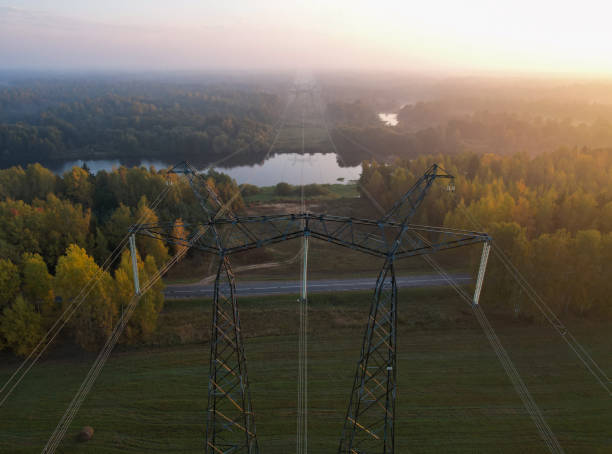 istock Support of a high-voltage power line with wires thrown across the river 1350764259