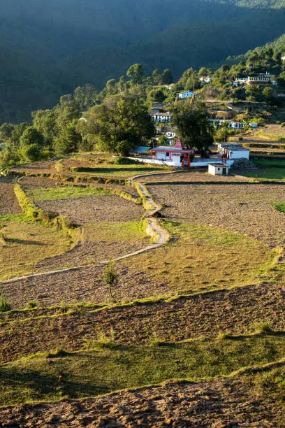 Beautiful scenic landscape of A village based in between the mountains captured during sunset. Indian Village situated in the hills of almora.