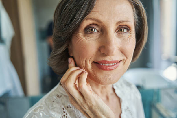 istock Female pensioner running hand over her cheek 1350766007