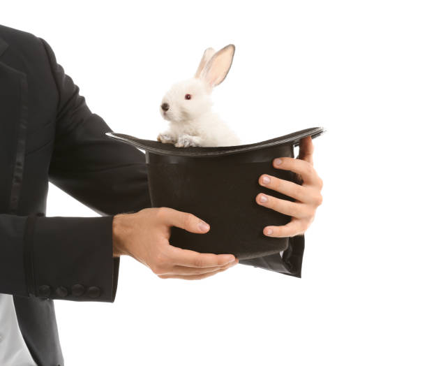 istock Magician holding hat with rabbit on white background 1350766844