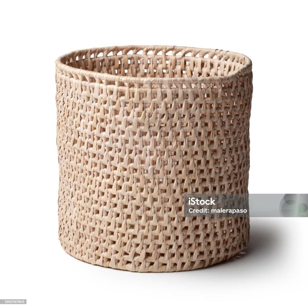 Natural plant fibre braided basket isolated on white background. Traditional handicraft product. Basket is handmade and is colored using natural dyes. The designs are ethnic in origin. Handicraft product of Indigenous tribes in Brazil. Basket Stock Photo