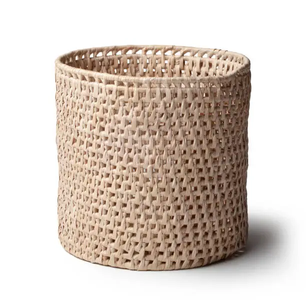 Photo of Natural plant fibre braided basket isolated on white background. Traditional handicraft product.