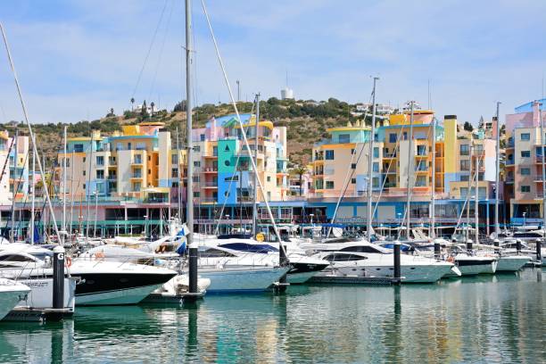 Albufeira marina, Algarve, Portugal. Yachts moored in the marina with apartments and waterfront businesses to the rear, Albufeira, Algarve, Portugal, Europe. albufeira photos stock pictures, royalty-free photos & images