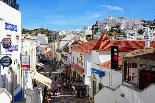 Elevated view of tourists walking along the Rua 5 Octubro shopping street, Albufeira, Portugal, Europe.