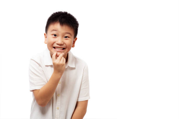 istock Excited kid with hand on chin isolated on white 1350769353