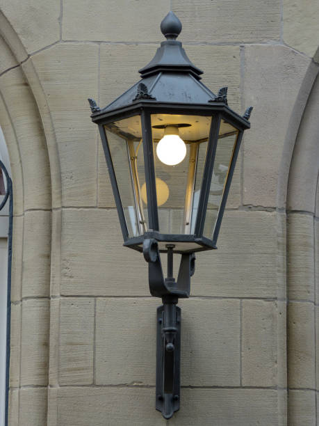 istock Lit electrical street lamp on a wall 1350771332