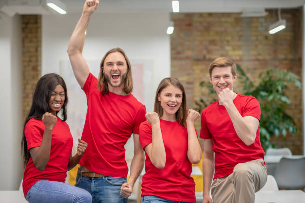 istock Young people in red tshirts looking joyful and happy 1350772183