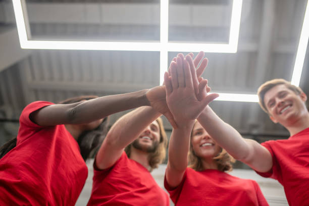 Young people in red tshirts looking joyful and happy stock photo